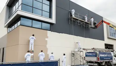 Professional commercial painters working on business exterior in Oak Park, IL