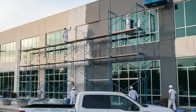 Professional commercial painters coating Oak Park IL business exterior with durable weatherproof paint